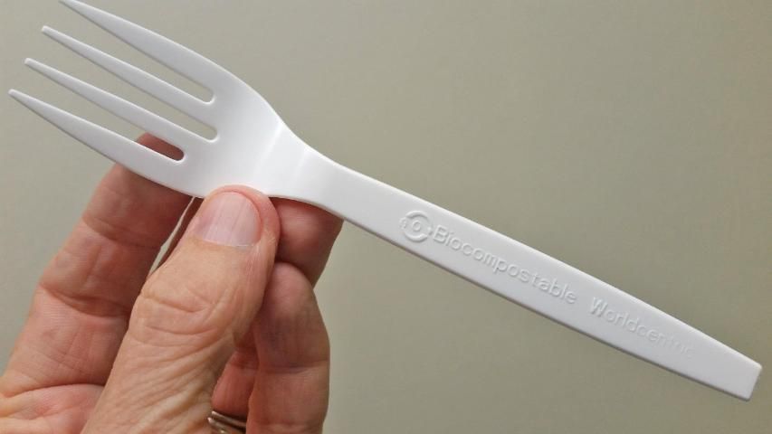 Image of a white plastic fork labeled as biocompostable.